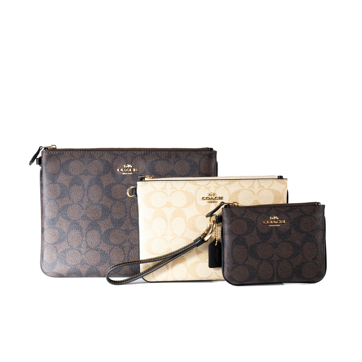 Coach Pouch Trio in Blocked Signature Canvas Signature Coated Canvas and Smooth Leather Interior Credit Card and Multifunction Pockets Zip-Top Closure and Fabric Lining Attached Wrist Strap Three Sizes: Large, Medium, Small Versatile and Travel-Friendly