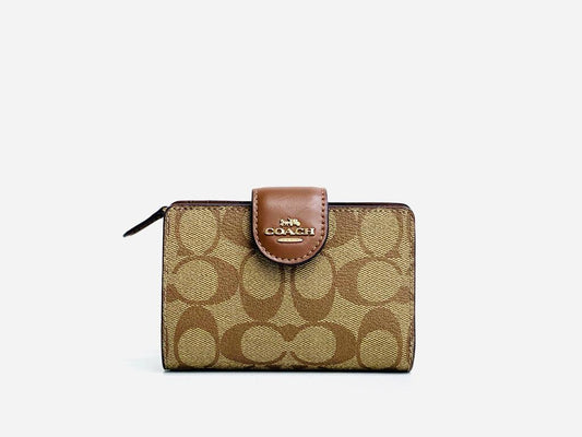 Coach Medium Corner Zip Wallet Signature Coated Canvas and Smooth Leather Seven Credit Card Slots Bill Compartment ID Window Snap Closure Zip Coin Pocket Dimensions: 12.70 cm (L) x 9 cm (H) x 1.30 cm (W)